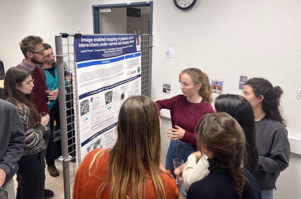 people looking at a scientific poster