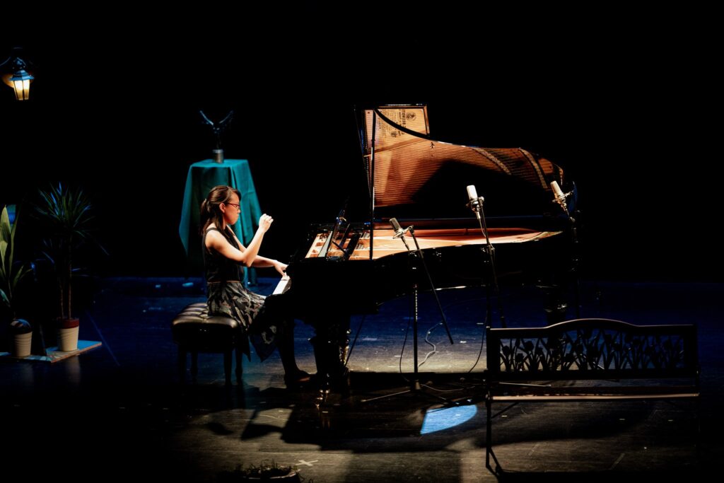 image of a person playing a grand piano