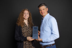 Brendan Rouse and Marta Rodríguez-Martínez are holding a certificate.