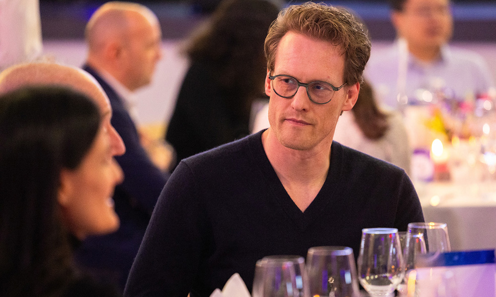 Man engaged in conversation at dinner table